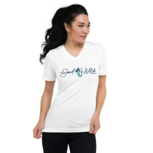 Woman wearing a white v-neck t-shirt with The SandWitch Truck logo featuring a mermaid and trident. The logo text is in a flowing blue script.
