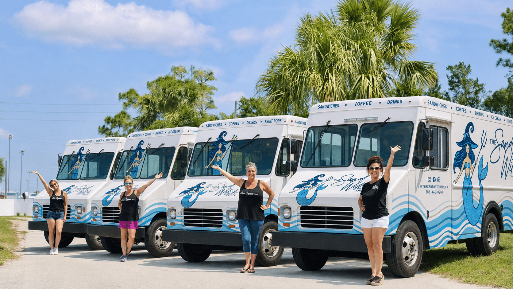 The SandWitch Truck catering fleet: four white food trucks with blue wave designs and mermaid logos, parked in a sunny lot with palm trees, overseen by four smiling women in branded t-shirts and shorts.