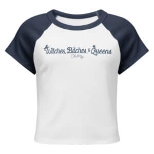 A white micro rib raglan baby tee with navy blue sleeves features the text "Witches, Bitches, & Queens" in a stylish blue script, with "Oh My" underneath.
